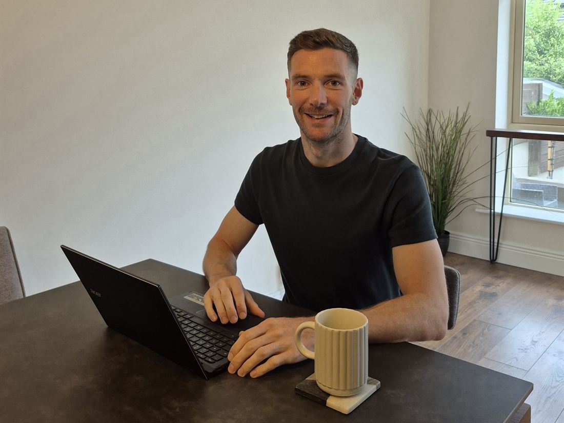 Enda Kilgallon writing training plans at his laptop